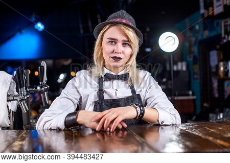 Expert Girl Bartender Is Pouring A Drink While Standing Near The Bar Counter In Bar