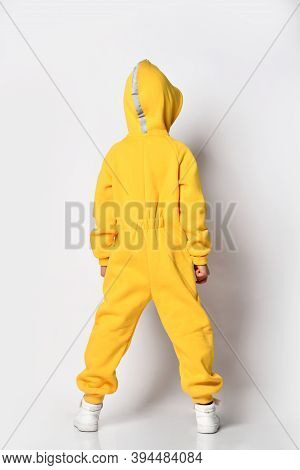 Back View Of A Full-length Guy In A Yellow Warm Jumpsuit With A Hood, A Sporty Demi-season Jumpsuit 