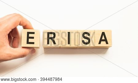 Word Erisa. Wooden Small Cubes With Letters Isolated On White Background With Copy Space Available