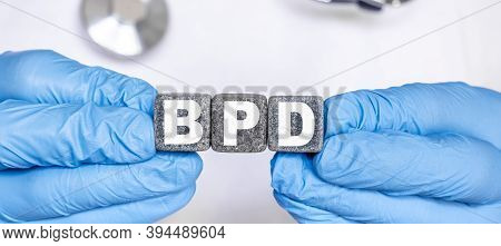 Bpd Borderline Personality Disorder - Word From Stone Blocks With Letters Holding By A Doctors Hands