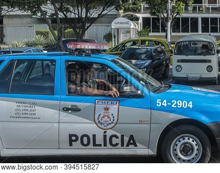 Rio De Janeiro, Brazil - December 23, 2008: Closeup Of Police Officers Sitting In Their Blue-gray Se
