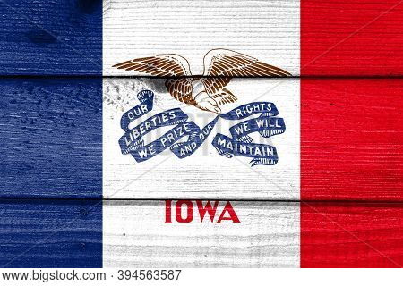 Iowa Flag Painted On Old Wood Plank Background. Brushed Natural Light Knotted Wooden Board Texture. 
