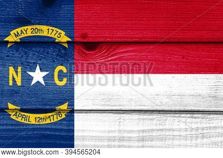 North Carolina Flag Painted On Old Wood Plank Background. Brushed Natural Light Knotted Wooden Board