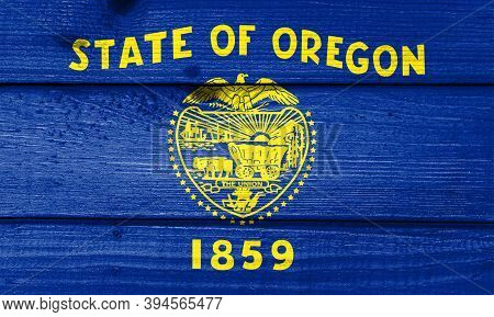 Oregon Flag Painted On Old Wood Plank Background. Brushed Natural Light Knotted Wooden Board Texture