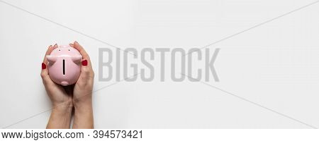 Woman Hands With Red Manicure Holds Money Piggy Bank On White Background. Business, Finance, Investm