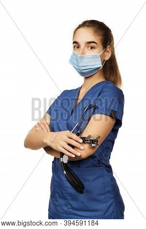 Young Beautiful Woman Doctor In Blue Surgical Gown With Stethoscope Isolated On White Background. Co