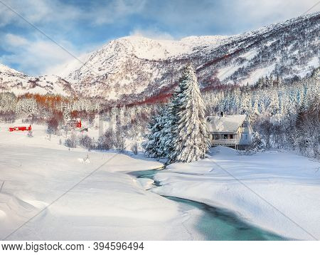 Fabulous Winter Scenery With Frozen River With Wooden Houses And Snow Covered Pine Trees Near Valber