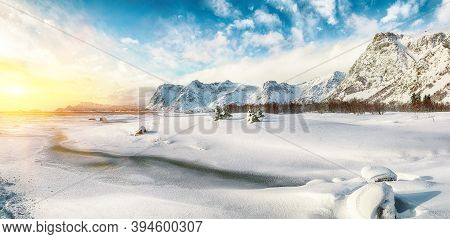 Winter Scenery With Frozen Fjord On Vestvagoy Island At Sunset With Snowy  Mountain Peaks Near Valbe