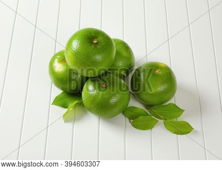 Five whole sweetie fruits (green grapefruits, pomelits) and leaves