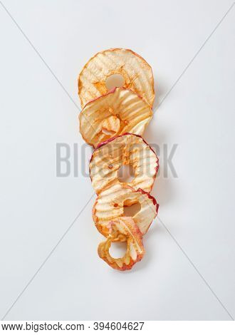 Dried apple slices (apple chips or rings) in a row