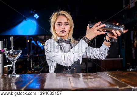 Professional Woman Bartender Demonstrates His Skills Over The Counter In The Bar