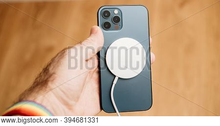 Paris, France - Nov 11, 2020: Magsafe Wireless Magnetic Charger On The Back Of New Iphone 12 Pro Max