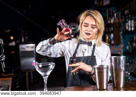 Girl Bartender Concocts A Cocktail At The Beerhouse