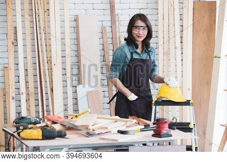 Beautiful Asian Adult Woman Wearing Jeans Clothes Working As A Carpenter In Room At Home. Concept Fo