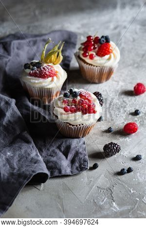 Homemade Muffin Next To A Bottle Of Milk On A Table And On A Dark Background With Fresh Berries Arou
