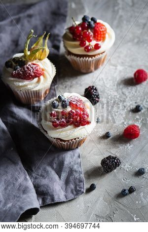 Homemade Muffin Next To A Bottle Of Milk On A Table And On A Dark Background With Fresh Berries Arou