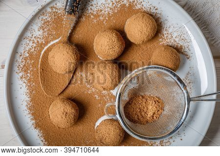 White And Dark Chocolate Truffles Or Energy Protein Balls Made With Dry Dates, Walnuts, Raisins, Cov