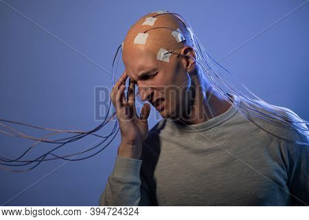 Man With A Bald Head With Wires Connected. Fear And Anxiety. Examination Of The Brain, Mind Control