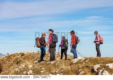 Altopiano Della Lessinia, Italy - Nov 8, 2020: A Group Of Seniors And Adults Hiking On The Lessinia 