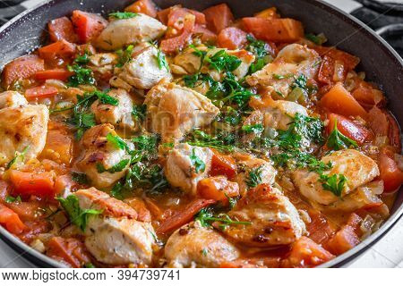 Chicken Cacciatore Is Cooked In A Frying Pan, Chicken Stew With Tomatoes And Red Pepper - Top View