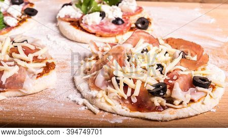Cooking Traditional Italian Mini Pizza, Pizzetta - Raw Mini Pizza With Tomato Sauce, Black Olives, J