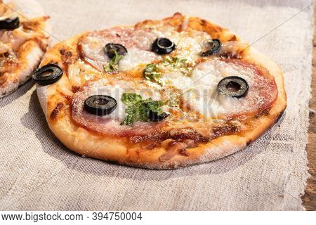 Traditional Italian Appetizer - Mini Pizza, Pizzetta With Sausage, Olives And Mozzarella Cheese On A