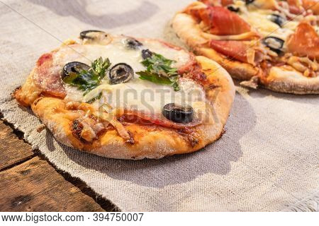 Traditional Italian Appetizer - Mini Pizza, Pizzetta With Sausage, Olives And Mozzarella Cheese On A