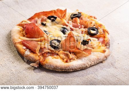 Traditional Italian Appetizer - Mini Pizza, Pizzetta With Jamon On A Linen Napkin Close-up - Roman S