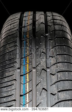 Seasonal Re-shoe Of Car Tires, Summer Wheel With A View Of The Tread On A Dark Background Front View