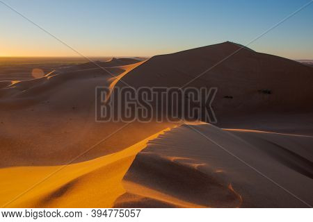 Wide Angle Shoot Of Sand Desert Dunes Of Erg Chigaga Moved By The Wind.  Sahara, At Sunrise. Morocco