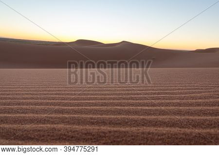 Close-up Desert Dunes Of Erg Chigaga, At  Sahara, Al Amanecer. Morocco. Concept Of Travel And Advent