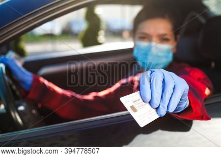 Young Female Driver Showing Coronavirus Health Card Or Immunity Passport,proof That A Person Has Dev