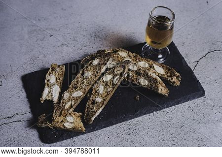 Typical Dessert Of Catalonia Based On Almonds. Carquinyolis With Muscat On Slate Plate