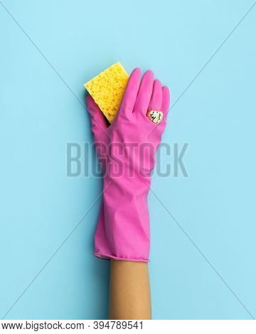 Womans Hand In Pink Rubber Glove Wash By Sponge Blue Background