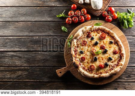 Homemade Pizza With Tomatoes Mozzarella Cheese Olives And Basil - Top Pof View.