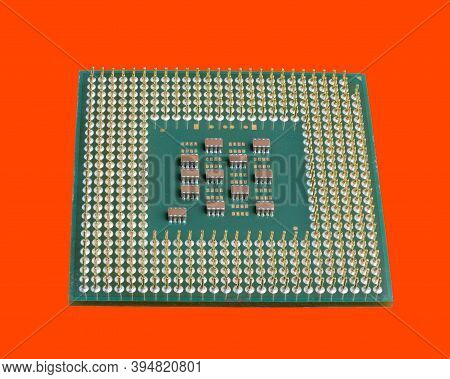 Photo Of A Cpu Chip Isolated On An Orange Background. Microprocessor, Central Processing Unit. Compu