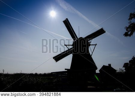 Kinderdijk, The Netherlands, August 2019. Conceptual Image At Sunset: The Silhouette Of The Mill Dom