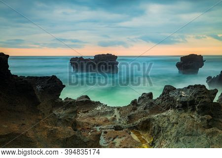 Picturesque Seascape. Amazing Landscape. Rock In The Ocean. Motion Waves. Silky Water. Long Exposure