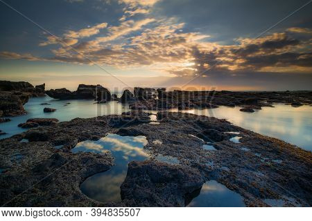 Beautiful Seascape. Long Exposure Rocky Beach During Low Tide. Panoramic Ocean View. Composition Of 