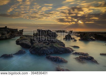 Beautiful Seascape. Long Exposure Rocky Beach During Low Tide. Panoramic Ocean View. Composition Of 