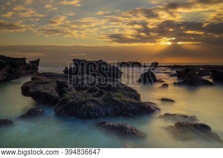 Beautiful Seascape. Long Exposure Rocky Beach During Low Tide. Panoramic Ocean View. Composition Of 