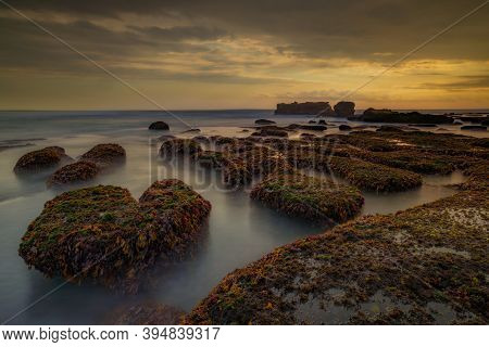 Amazing Seascape For Background. Beach With Rocks And Stones. Low Tide. Motion Water. Cloudy Sky. Sl