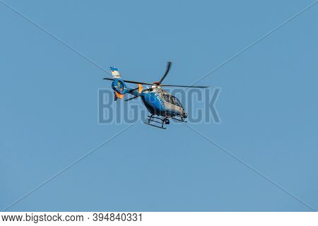 Germany Koblenz 05.04.2020 D-hrpb Police Helicopter Flies Over The City In Blue Sky Background Searc
