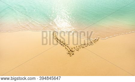 A Heart Shape Written On Golden Brown Sand Were Delete By  Pastel Green Color Water Frome The Sea On
