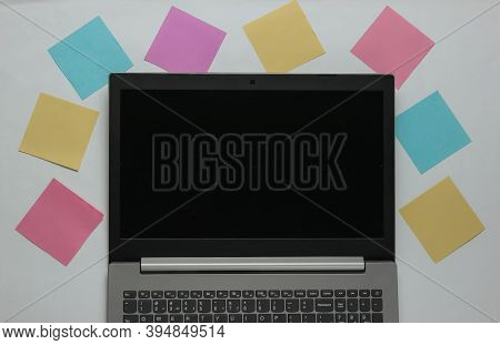 Minimalistic Office Concept. Lptop And Lot Of Memo Papers On White Background. Top View
