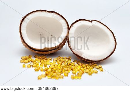 Health Care - Nutritional Supplement And Healthy Food - Halved Coconut With Scattered Gold Gel Capsu