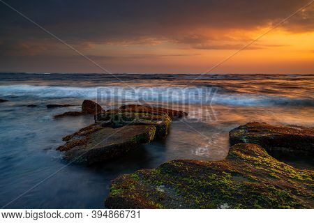 Beautiful Seascape. Beach With Stones Covered By Seaweeds. Low Tide. Composition Of Nature. Motion W