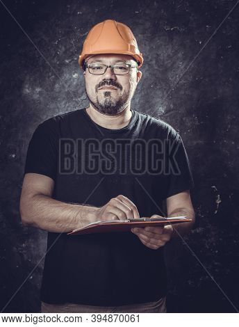 Middle-aged Man In A Helmet Construction Superintendent