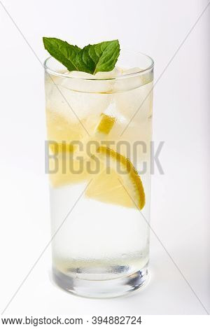 Sweaty Glass Of Lemonade With Mint On A White Background