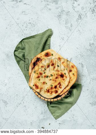Fresh Naan Bread On Gray Cement Background With Copy Space. Top View Of Several Perfect Naan Flatbre